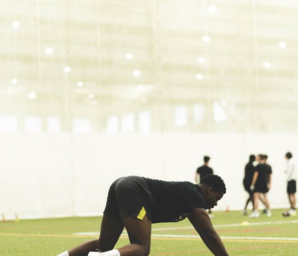 Man in motion during a dynamic warm-up exercise.